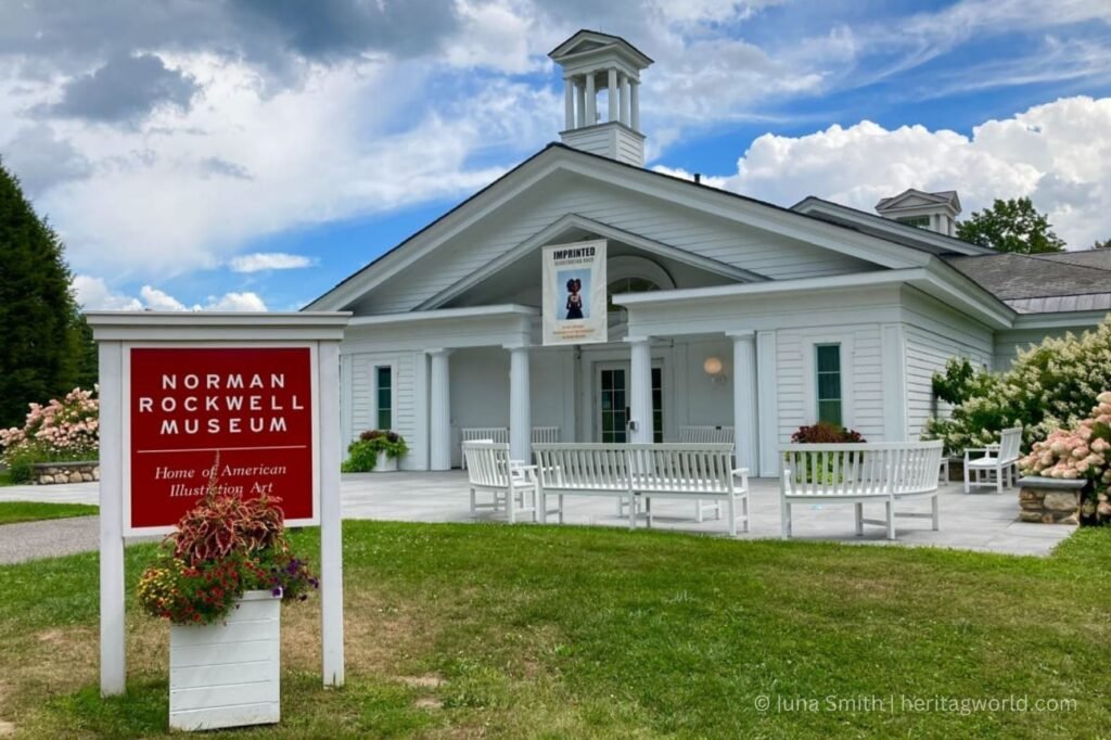 a white building with a sign and a lawn with Vandalia State House State Historic Site in the background